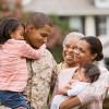 African American military father hugging family